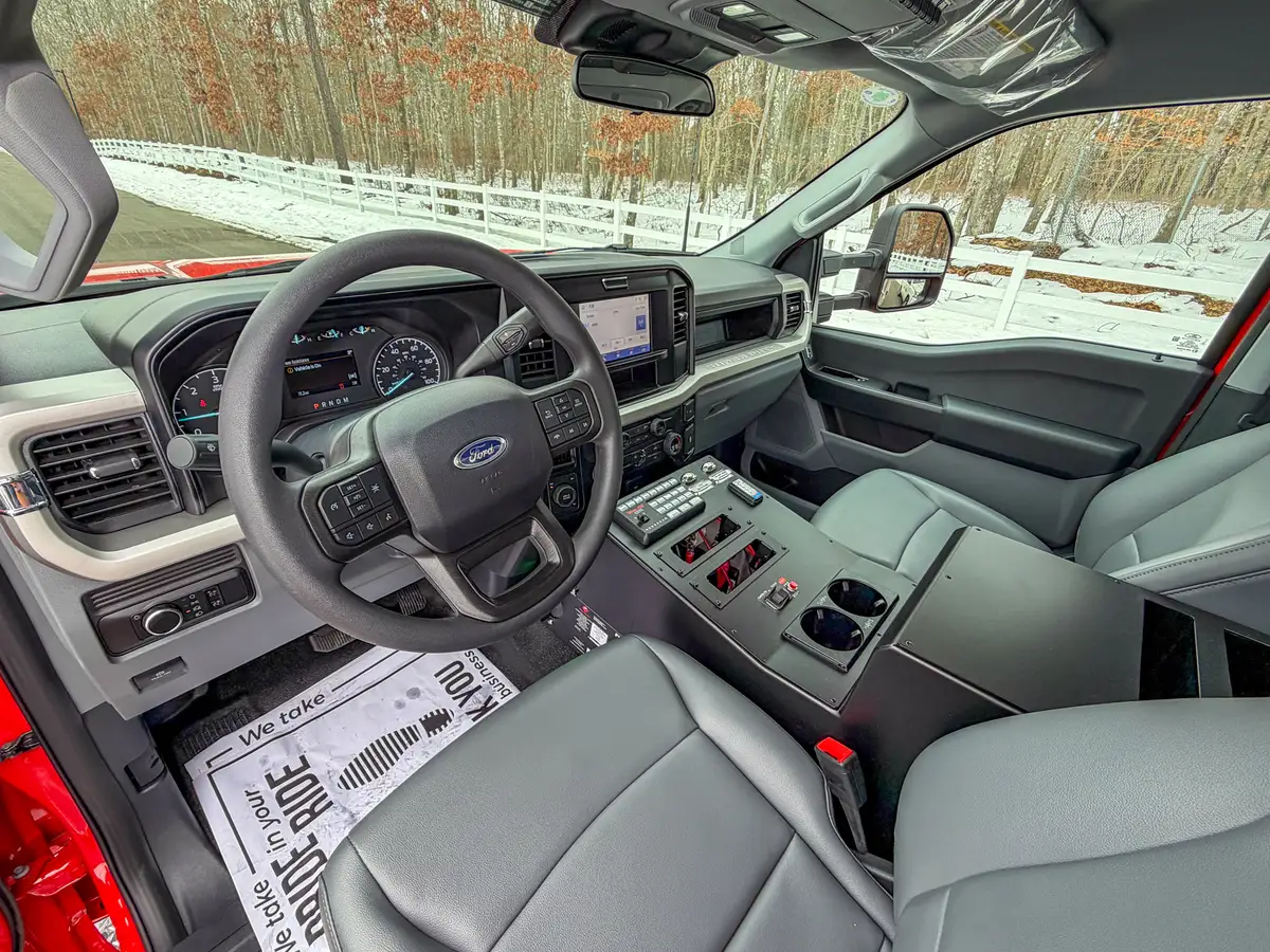 Passenger-side dashboard and steering wheel from cabin interior.